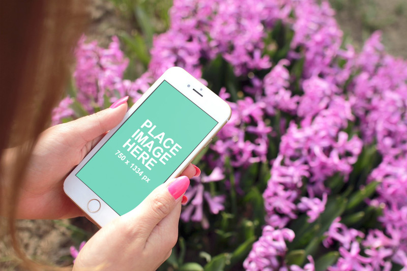 Woman holding iPhone 6 with flowers